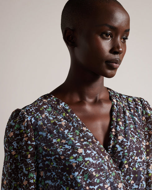 CHERELA-Dresses-It might be downright impossible to not look amazing in CHERELA. With its dropped waist and ruching on the front, pair with a sleek up-do and you're good to go.The fabric of this product is made of 100% recycled polyester. Using recycled polyester helps divert plastic waste from ending in landfills, and helps us to reduce our dependence on virgin materials. Mini dress Long sleeved V-neck Ruched front Ditsy floral print Dropped waist Awuoi is 5'10.5" / 1.79m and wears Light Blue in a Ted size